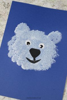 a blue card with a bear's face drawn on it