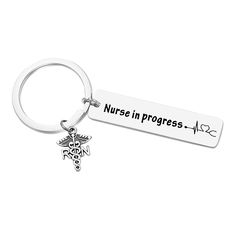 a keychain that says nurse in progress with a cadus symbol on it