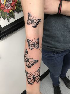 a woman's arm with butterflies on it