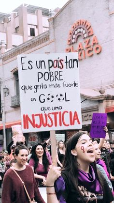 a group of people holding signs in the street