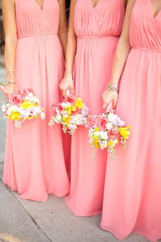 the bridesmaids are wearing pink dresses with yellow and white flowers in their bouquets