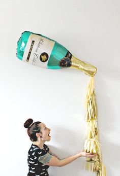 a woman is pouring champagne into a bottle