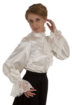 What could be more romantic and feminine than shimmering satin and frothy lace? The satin blouse features an attached lace trimmed jabot and closes with satin-covered buttons, and very full long sleeves with a deep ruffle of lace at the cuff. The blouse has a button closure down the front and comfortable elastic at the wrists. Proudly designed and made in America by Recollections. Poly satin; Dry clean or hand wash.The model finishes the look with a skirt which is priced separately. Long Sleeve Satin Top For Wedding, Elegant Lace Blouse With Ruffles, Elegant Ruffled Lace Blouse, Formal Lace Blouse With Ruffles, Elegant Lace Top With Ruffled Collar, Party Blouse With Lace Trim And Ruffled Collar, Ruffled Collar Blouse For Wedding, Wedding Lace Blouse With Ruffles, Formal Long Sleeve Blouse With Lace Trim