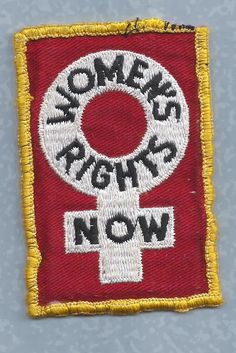 a red and yellow patch with the words women's rights now written on it