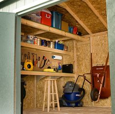 the inside of a shed with tools and other items on shelves, including an air mover