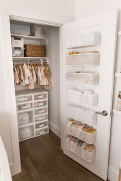 an organized closet with white shelves and drawers