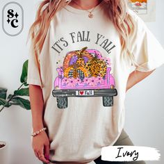 Embrace the cozy vibes of autumn with our adorable "IT'S FALL Y'ALL" shirt! Featuring a cute pink pickup truck loaded with a variety of pumpkins painted in leopard patterns, checkered designs, polka dots, sparkles, and flowers, this shirt is the perfect blend of fun and festive. Whether you're headed to a pumpkin patch or just enjoying the season, this It's Fall Y'all Shirt is a must-have for your wardrobe. Made from soft Comfort Colors fabric, this Tshirt will keep you feeling great all day long. Celebrate the season in style with this charming pumpkin patch t-shirt. The vibrant design and playful text make it an excellent choice for any fall event, from Halloween parties to casual outings. Show off your love for autumn and all things pumpkin with this cute Halloween tee. If fall is your Trendy Cartoon Print Tops For Fall, Playful Cartoon Print T-shirt For Fall, Casual Fall T-shirt With Cartoon Print, Pink Graphic Print T-shirt For Fall, Relaxed Fit Cartoon Print Top For Fall, Fun Fall Tops With Cartoon Print, Playful Letter Print Tops For Fall, Playful Tops With Letter Print For Fall, Playful Relaxed Fit Tops For Fall