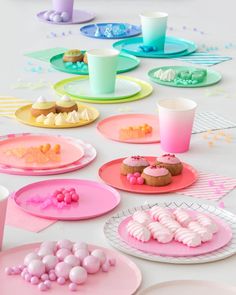 a table topped with plates and cups filled with desserts