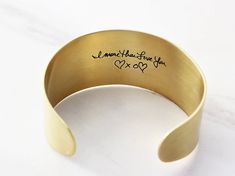 "Actual Handwriting Bracelet / Signature Bracelet / Custom Cuff Bracelet Our custom Handwriting Cuff Bracelet is made from actual hand-writings, drawings, and signatures photographed from cards and documents from the past. All we need is a photo of the writing - phone photos work great! Choose large text, medium text, or mini text along with brass, copper and aluminum metals in a brushed satin finish. Packaged in our Tom Design logo-stamped gift boxes with optional gift wrap. Preserve the past w Gift Cuff Bangle With Stamped Detail, Stamped Bangle Cuff Bracelet Gift, Engraved Cuff Bracelet As Gift, Engraved Cuff Bracelet Gift, Stamped Cuff Bracelet Gift, Stamped Cuff Bracelet As Gift, Handwriting Signature, Personalized Cuff Bracelets, Gold Bar Necklace Personalized