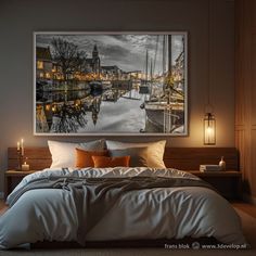 a bedroom with a large painting hanging above the bed and candles on the nightstands