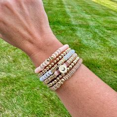 Introducing our 'Heishi Haven' bracelet stack – a spirited stack that redefines the rhythm of style! Each bracelet is a vibrant heishi bead composition, a celebration of color and texture that harmonizes seamlessly for a look that's as playful as it is chic. This Stack gives off Boho Vibes - Real Pretty!! Lead & Nickel Free Bracelets are 'one size fits most' and are designed to fit wrists up to 7.5" comfortably Set of 6 Bracelets Peachy Pink, White, Beige, light cocoa brown and Gold Hues Please be aware that due to the unique and handmade nature of each product, colors, shapes, and bead sizes may vary slightly from the photos and descriptions. Trendy Stackable Heishi Bead Bracelets, Stacked Heishi Beads Jewelry With Round Beads, Adjustable Stacked Beaded Bracelets For Everyday, Everyday Stackable Heishi Beads Stretch Bracelet, Bead Sizes, Beige Light, Cocoa Brown, Free Bracelet, Heishi Beads