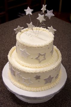 a three tiered cake with stars on top