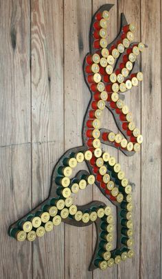 a sign made out of beer bottle caps on a wooden wall with a man running