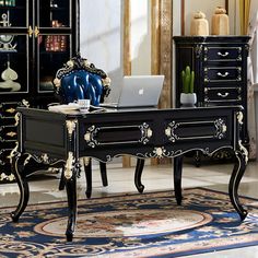 a desk with a laptop on top of it in front of a dresser and mirror