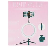 a pink poster with a camera and light on it's tripod for photography