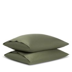 two olive green pillows sitting on top of each other