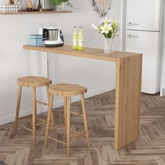 two wooden stools sit at the end of a counter