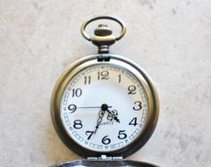 "Ship pocket watch, ship pocket watch has a sailing ship mounted on front case of pocket watch. The ship has been sealed with clear resin. The chain is 13\" in length and has tiger eye beads adorning it. The beads are 2\" in length and are on a lobster clasp so they can be worn on the watch chain or removed with ease if you would like to wear a plain chain for the day. The watch has a nice face featuring a white dial with black numerals. This is a battery operated pocket watch. Watch can be open Men's Steampunk Style, Bronze Dragon, Nice Face, Unique Pockets, Mechanical Pocket Watch, Large Numbers, Watch Battery, Fox Head, Tiger Eye Beads