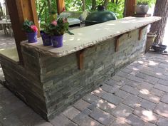 an outdoor bar with potted plants on it