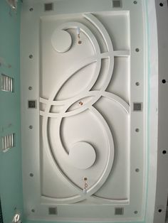 an artisticly designed ceiling in the shape of a trellis with circles and swirls