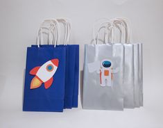 three bags with different designs on them, one has an astronaut and the other is a rocket ship