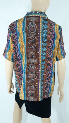 "80's Women's Shirt Short Sleeve Blue Brown Gold Turquoise Cool Geo Abstract Print Button Down Like New Vintage by HILL ARCHER Size XL Super cute fun summer vacation! Button down, black buttons, short sleeve, tiny collar, gather across shoulder, drapy silky light weight fabric, colorful. Blue brown gold pink gold geo colorblock abstract print. Excellent Condition. Easy to wear casual chic vintage for the disco sporting life. MEASUREMENTS: Length - 27\" Bust (underarms to underarms) - 23\"x 2 Sle Vintage Blue Beach Blouse, Vintage Blue Blouse For Beach, Vintage Blue Blouse For The Beach, Retro Blue Button-up Hawaiian Shirt, Blue Retro Hawaiian Button-up Shirt, Blue Collared Bohemian Tops, Multicolor Bohemian Top With Camp Collar, Bohemian Multicolor Camp Collar Top, Blue Bohemian Shirt With Graphic Print