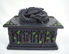 a small black box with ivy growing on it