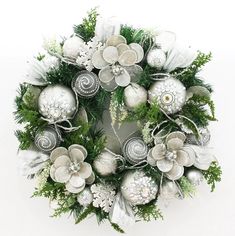 a christmas wreath with silver ornaments and greenery