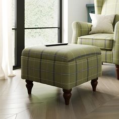 a living room with a chair and ottoman