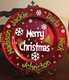 a merry christmas plate sitting on top of a wooden table