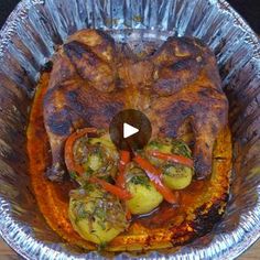 a metal pan filled with food on top of a wooden table