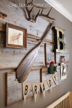 there is a wooden board with pictures on it and an arrow hanging from the wall