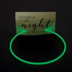 a green glow bracelet with the words let's light up the night on it