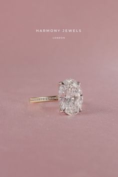 a diamond ring with the words harmony jewels on it's front and back side