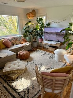 a living room filled with furniture and lots of plants