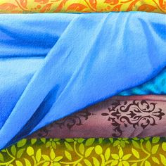 a painting of a person's arm with tattoos on it, under a blue blanket