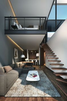 a modern living room with stairs leading up to the second floor and an open staircase