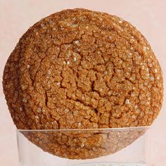 a round cookie sitting on top of a glass bowl