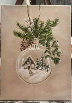 a christmas ornament is hanging on a canvas