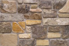 a stone wall with several different colored rocks