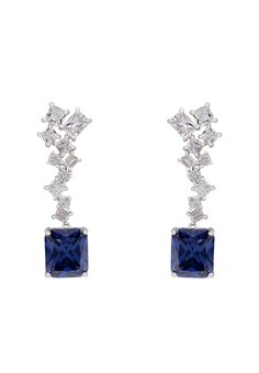 The Diana Tanzanite Drop Earrings are perfect for when you want to add a touch of sparkle and elegance to your outfit. This piece is handmade from 925 sterling silver. A large, rectangular tanzanite gemstone hangs from an intricate setting with a zig-zag design, adorned with simulated diamonds, making these earrings even more special. Why not add a touch of luxury and colour to your attire with the rich blue of the tanzanite. At only 15 grams, these eye-catching earrings are lightweight and comf Tanzanite Drop Earrings, Diana Son, 24th Wedding Anniversary, Butterfly Earrings Gold, Drop Earrings Silver, Hamsa Necklace, Tanzanite Gemstone, Stunning Earrings, Silver Drop Earrings