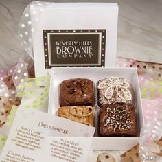 a box filled with brownies and cookies on top of a table