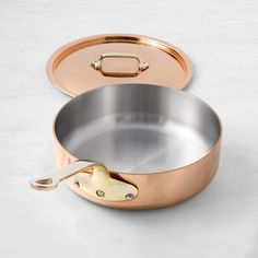 an empty copper pan on a white counter