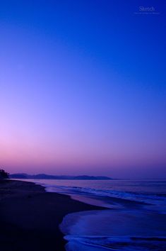 the sky is purple and blue at dusk