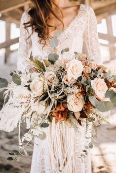 a woman holding a bouquet of flowers in her hands