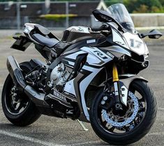 a white and black motorcycle parked in a parking lot