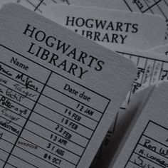 two harry potter library id cards sitting on top of each other