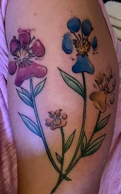 a close up of a person's thigh with flowers on it