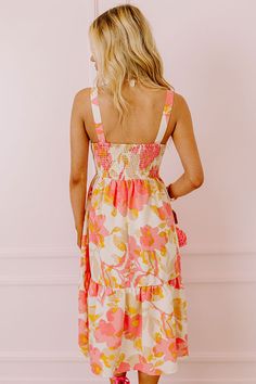 – Stay sweet and stunning in our beautiful dress – Lightweight, 100% polyester material patterned in a yellow and pink hued floral print – Fully lined bodice with a soft skirt slip – V-cut neckline with cutout and tie closure accent – Fitted bodice with a straight smocked back – Sleeveless 1-inch shoulder straps – Relaxed tiered skirt silhouette that falls into a straight hemline Measurements S : Bust 30", Hip 34", Length 40.5", Waist 26". M : Bust 32", Hip 36", Length 41", Waist 28". L : Bust 3 Spring Peach Dress With Smocked Back, Pink Sundress With Smocked Back, Pink V-neck Sundress With Tie Back, Beige Floral Print Sundress With Spaghetti Straps, Beige Floral Print Sundress For Vacation, Pink Floral Print Sundress With Spaghetti Straps, Pink Midi Dress With Tie Back For Brunch, Pink Sundress With Spaghetti Straps And Floral Print, Pink Sundress With Floral Print And Spaghetti Straps