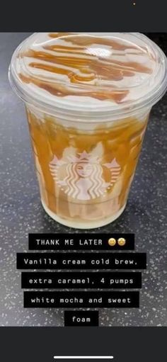 a plastic cup filled with liquid sitting on top of a black counter next to a sign that says thank me later vanilla cream cold brew